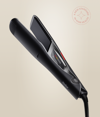 Astral Black Omnia Styler Max open at an angle, showing the plates, temperature controls and cord.