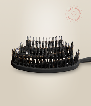 Side close-up of the OmniFlex Vent Brush's curved head and mixed-height bristles.